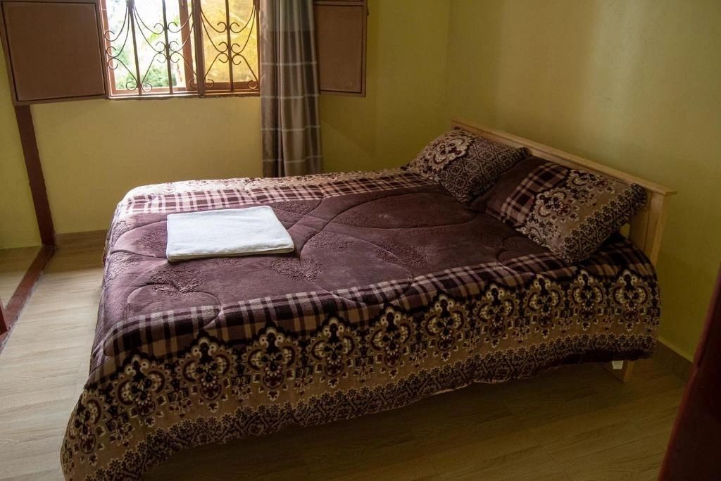 Ntebeko Homestay warmly lit double bedroom